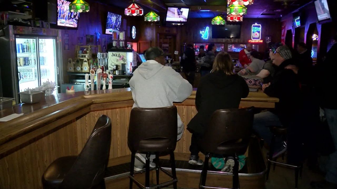 Patrons huddle around the bar at Limanski's Pub in West Allis, Wisconsin, on Wednesday, May 13, 2020.