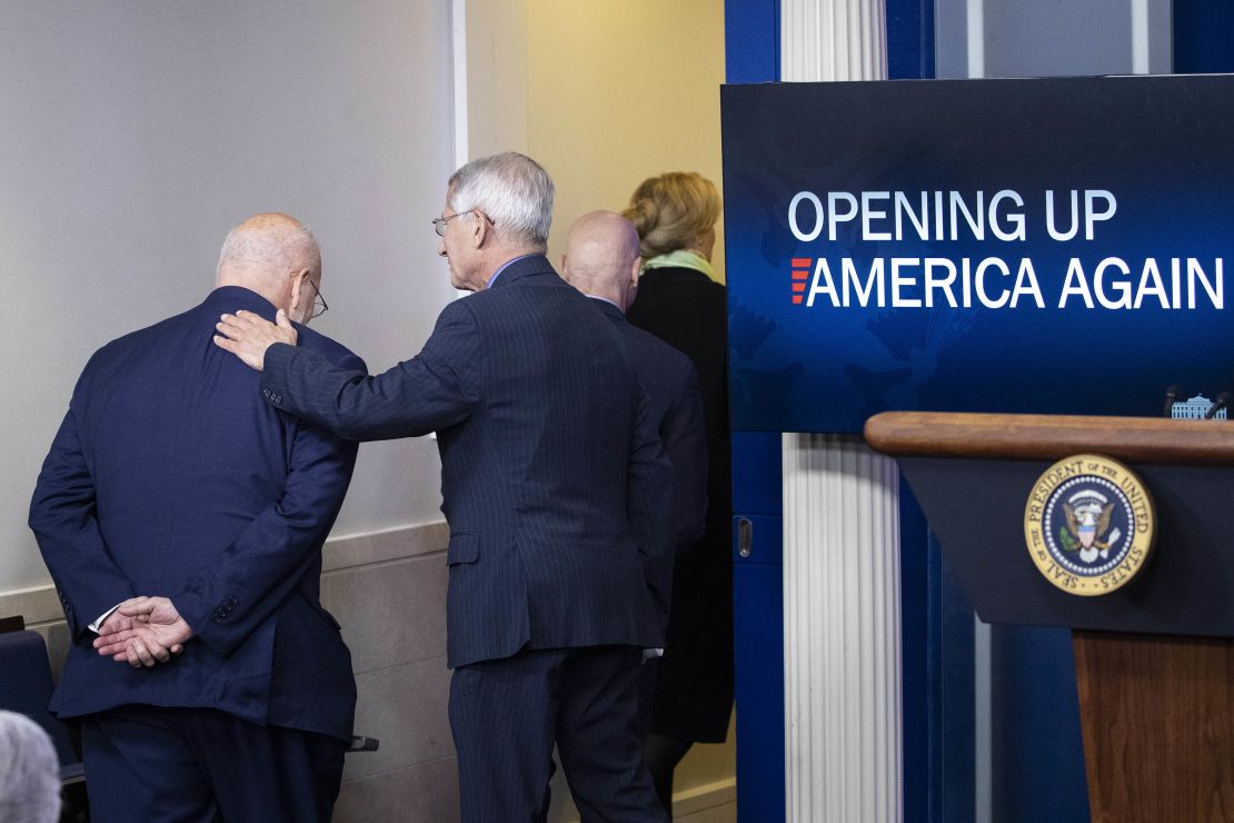 Centers for Disease Control and Prevention Director Dr. Robert Redfield, left, and Dr. Anthony Fauci, director of the National Institute of Allergy and Infectious Diseases, depart after accompanying President Donald Trump at an April 16 press briefing.
