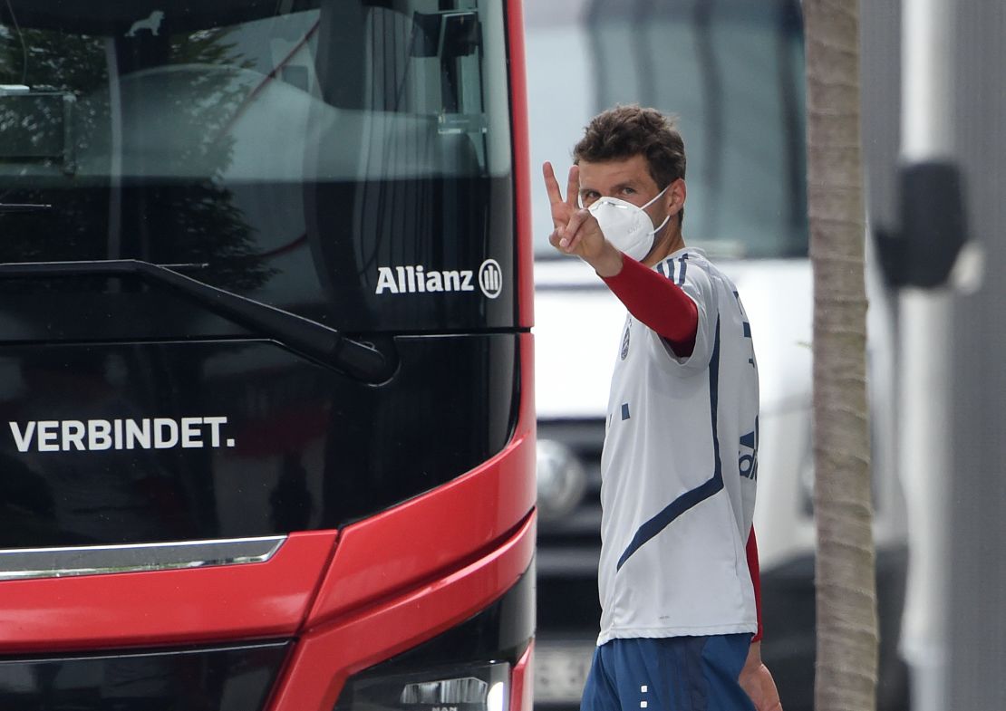 Bayern Munich striker Thomas Mueller wears a face mask as he leaves a training session.
