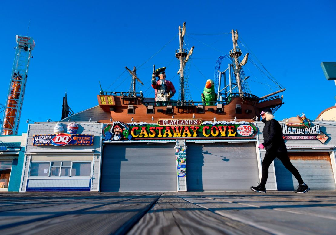 A woman walks past a closed amusement park in Ocean City, New Jersey on January 8, 2020.