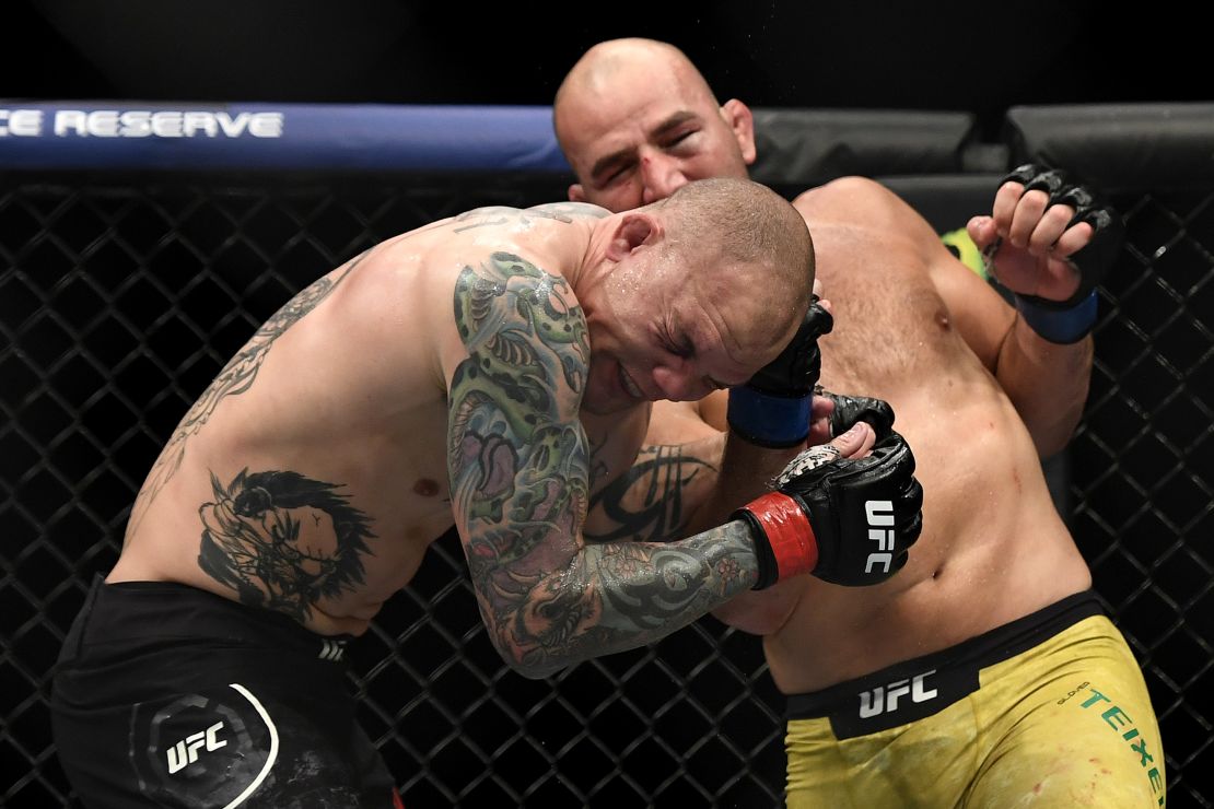 Smith is punched by Glover Teixeira in their light heavyweight bout.
