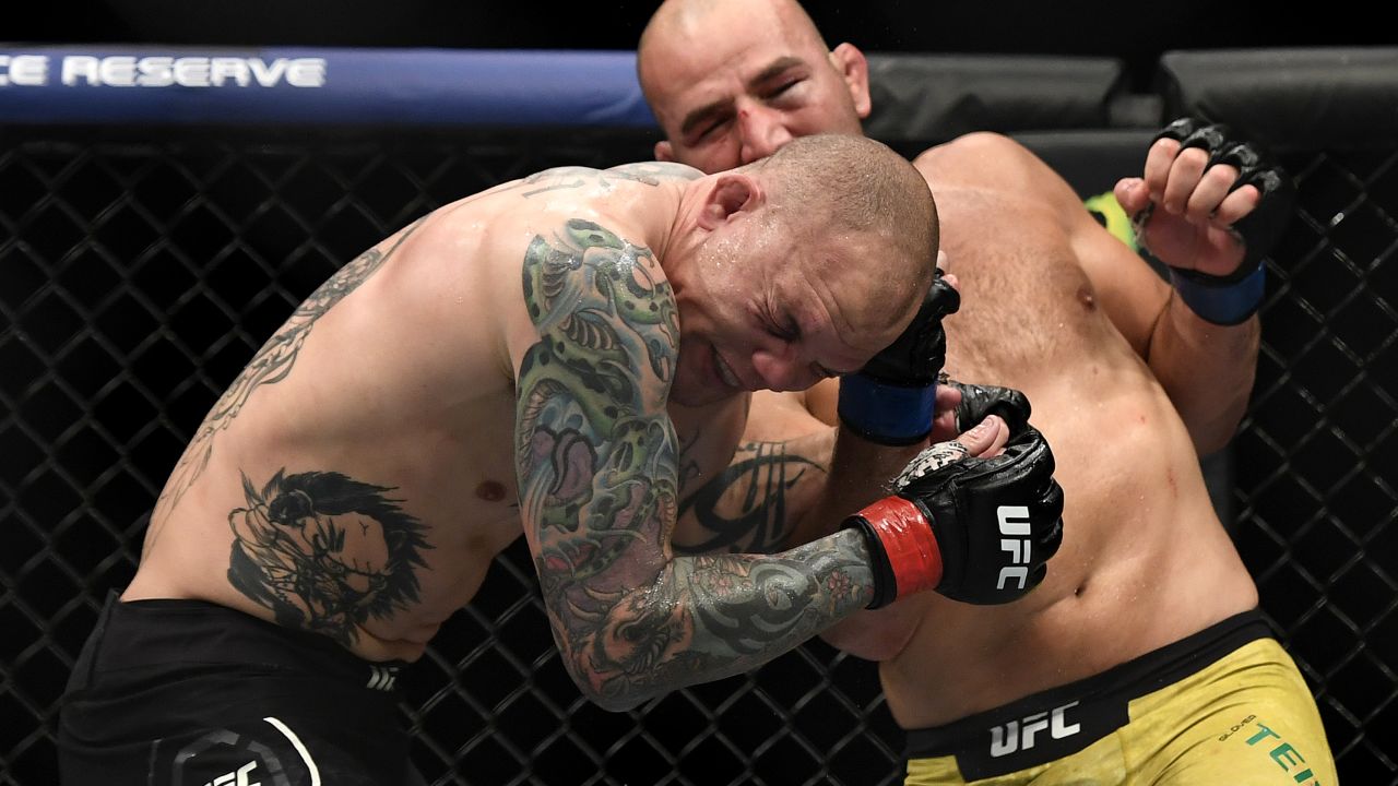 Smith is punched by Glover Teixeira in their light heavyweight bout.