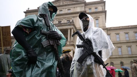 Protesters carrying weapons gather at the Michigan Capitol Building on May 14, 2020 in Lansing, Michigan. 