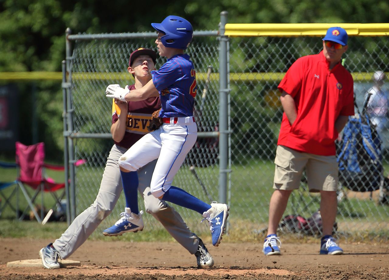 Youth baseball players collide at first base <a href="https://www.stltoday.com/news/local/metro/youth-baseball-tournament-in-cottleville-a-sign-of-strange-new-normal/article_fd43d2f6-f0e8-52fe-bf2f-16632750fdf7.html" target="_blank" target="_blank">while playing in a tournament</a> in Cottleville, Missouri, on Saturday, May 9. The tournament's organizers created rules to encourage social distancing, but there were times when players still came into close contact with one another.