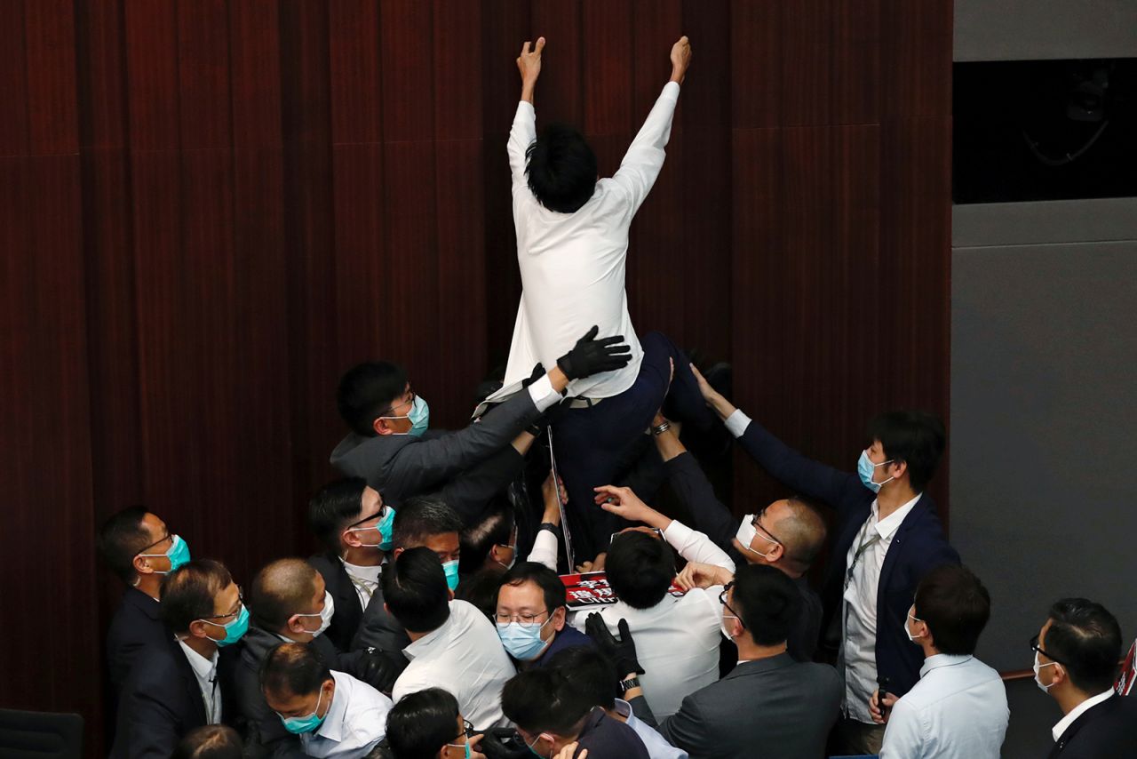 Pro-democracy lawmaker Eddie Chu Hoi-dick scuffles with security and pro-China lawmakers during a House Committee meeting in Hong Kong on Friday, May 8. Chu and several other lawmakers were carried out of the room by security after they didn't comply with chairman Starry Lee's warnings to sit down, <a href="https://www.bloomberg.com/news/articles/2020-05-08/hong-kong-lawmakers-scuffle-after-china-loyalists-assert-control" target="_blank" target="_blank">Bloomberg reported.</a>