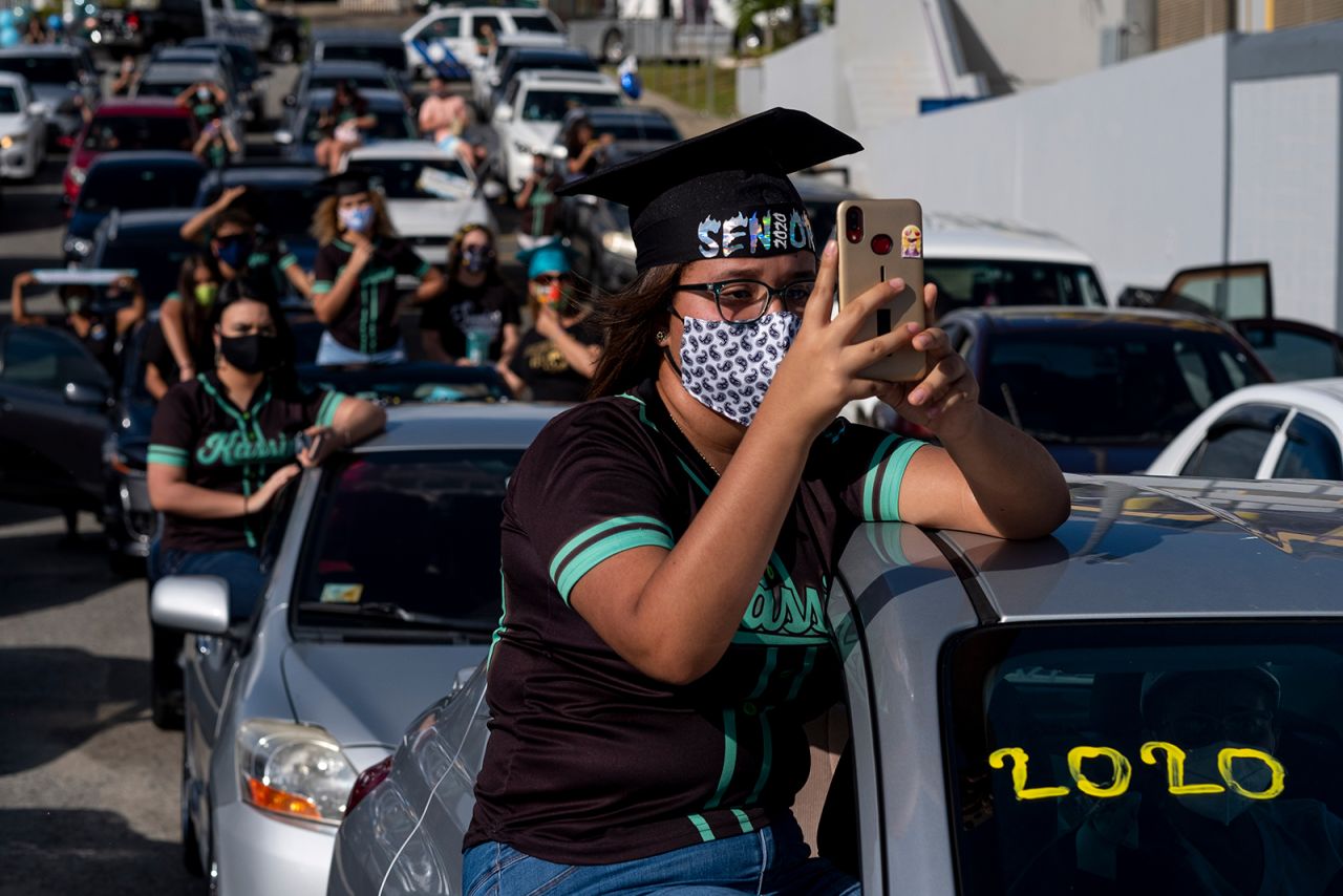Students from Ramon Power y Giralt High School attend their graduation ceremony, which was held in a parking lot in Las Piedras, Puerto Rico, on Wednesday, May 13. Students had to stay inside their vehicles during the event.
