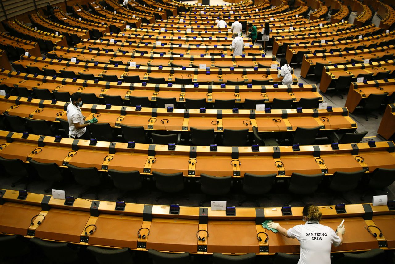 A sanitizing crew cleans up Wednesday, May 13, before a European Parliament session in Brussels, Belgium.