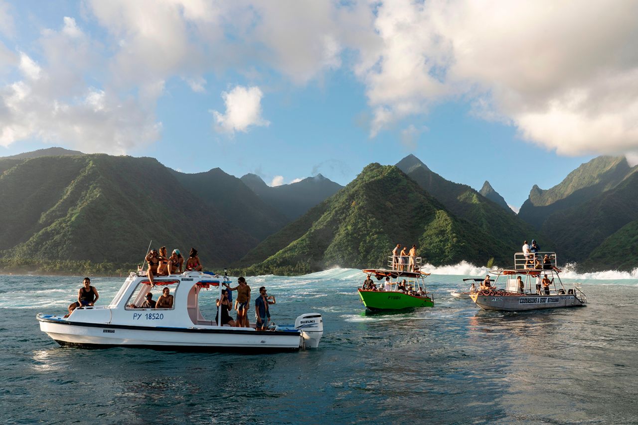 Spectators gather to watch surfers in Teahupoo, Tahiti, on Monday, May 11. It was the first big swell since local lockdown measures had been lifted.