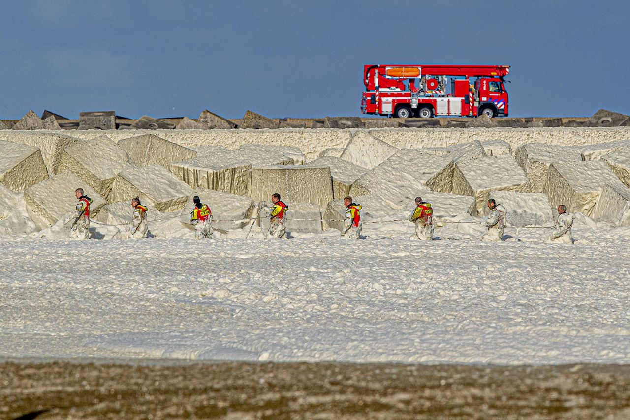 Members of the Royal Netherlands Sea Rescue Organization brave hot foam as they look for missing surfers in The Hague on Tuesday, May 12. Five surfers were killed after <a href="https://www.cnn.com/2020/05/13/sport/dutch-surfers-drown-scli-intl-spt/index.html" target="_blank">a huge layer of foam hampered efforts to rescue them.</a>