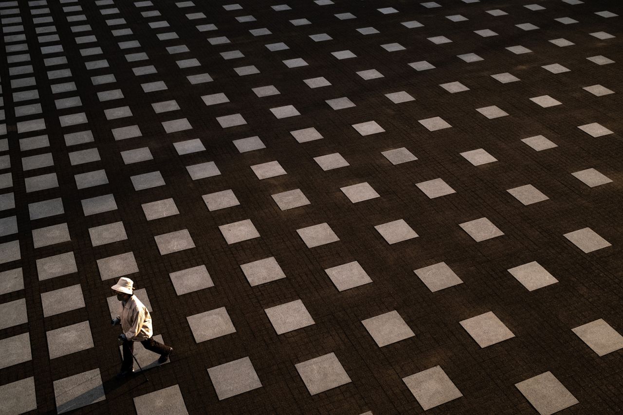 A woman walks in a park in Yokohama, Japan, on Sunday, May 10.