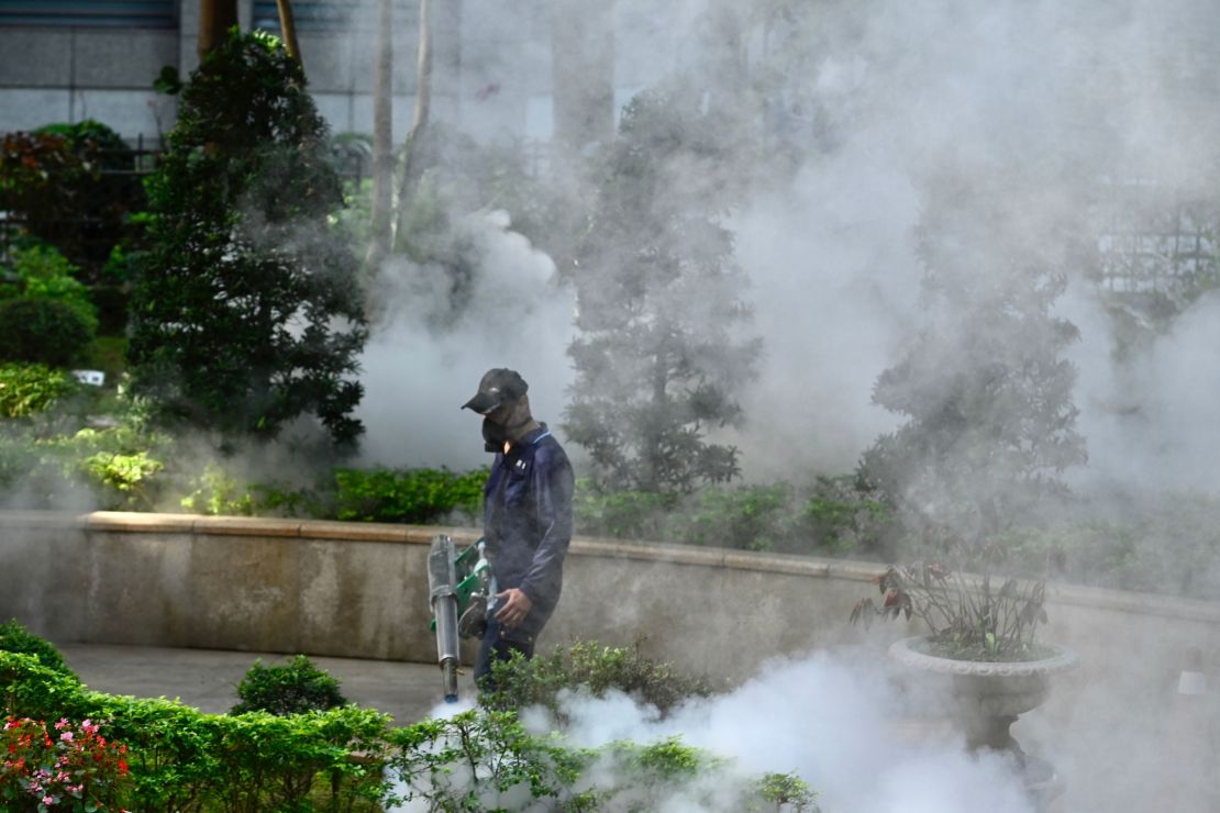 A mask-clad worker disinfects a park to prevent the spread of the coronavirus in New Taipei City on March 9.