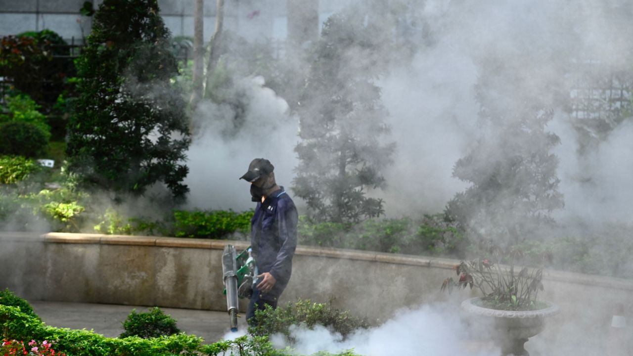 A mask-clad worker disinfects a park to prevent the spread of the coronavirus in New Taipei City on March 9.