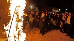 Ultra-Orthodox Jews light a Lag BaOmer bonfire in Jerusalem's religious Mea Shearim neighbourhood amid an Israeli health ministry's order to maintain social distancing and to cancel all Lag BaOmer holiday celebrations, on May 11, 2020, during the COVID-19 pandemic. - The Jewish holiday of Lag BaOmer marks the anniversary of the death of Talmudic sage Rabbi Shimon Bar Yochai approximately 1,900 years ago. (Photo by MENAHEM KAHANA / AFP) (Photo by MENAHEM KAHANA/AFP via Getty Images)