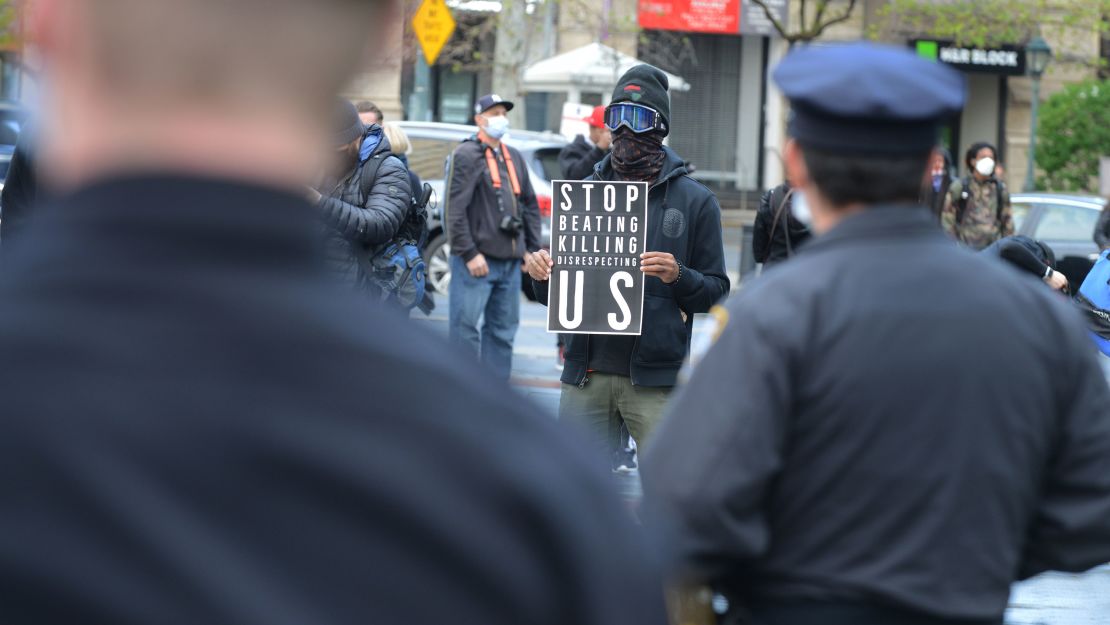 A group of protesters, bound together with yellow caution tape, marched on New York's Police Headquarters on May 11, 2020, decrying police brutality against African-Americans.