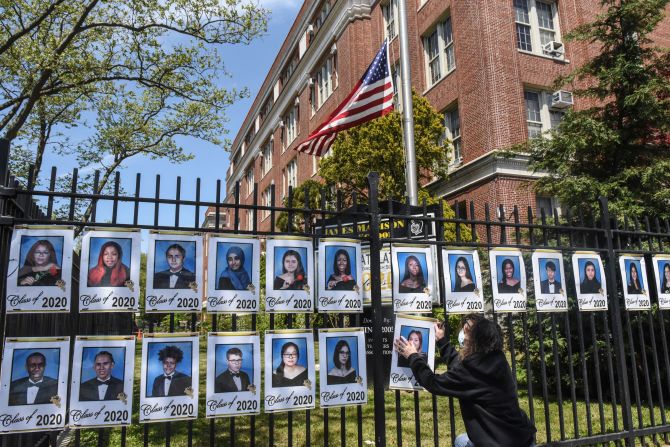 Luz Carlson installs a photographic tribute to the graduating seniors of James Madison High School in New York on May 14.