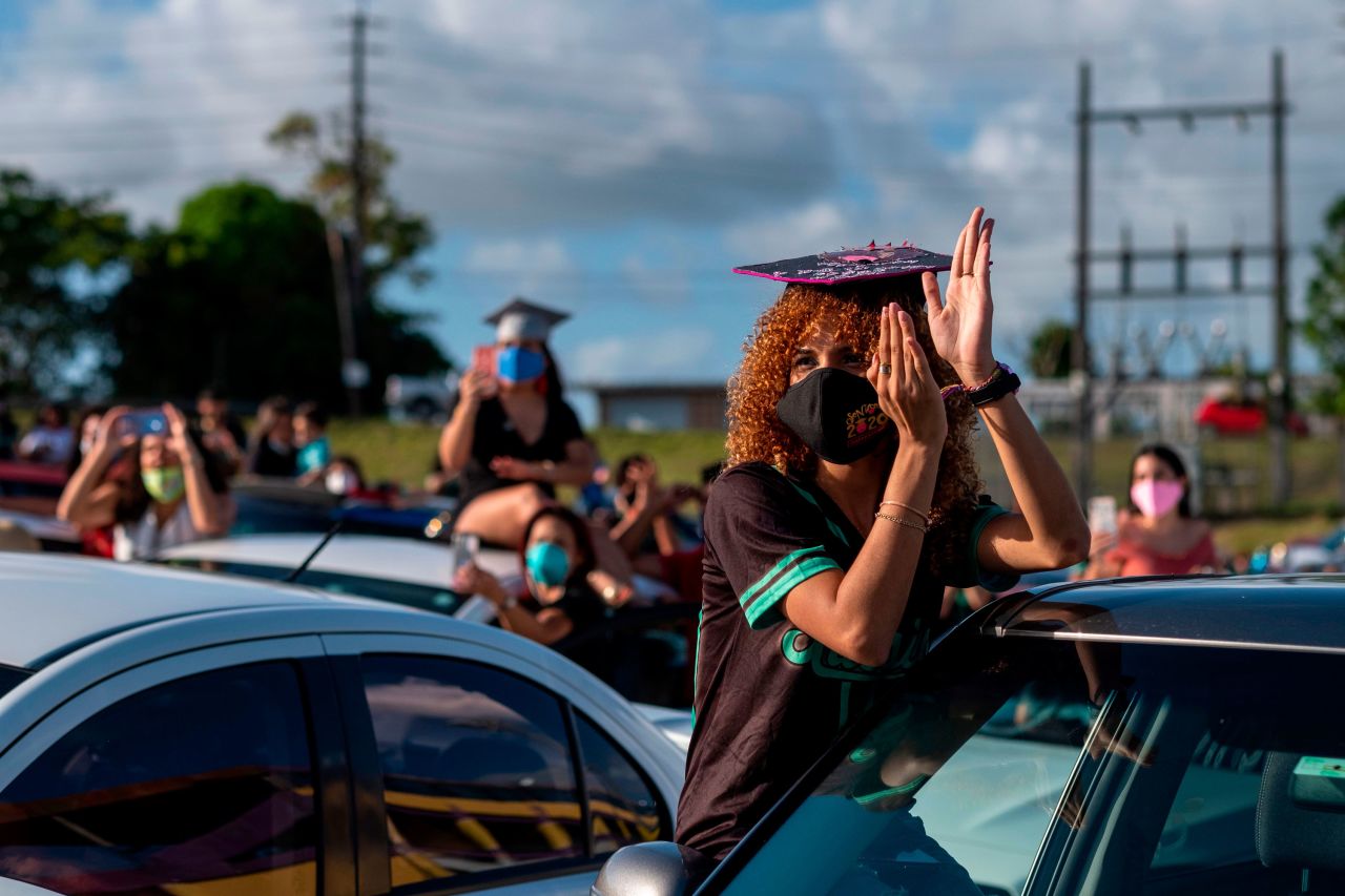 Students from Ramon Power y Giralt High School attend their graduation ceremony, which was held in a parking lot in Las Piedras, Puerto Rico, on May 13. Students had to stay inside their vehicles during the event.