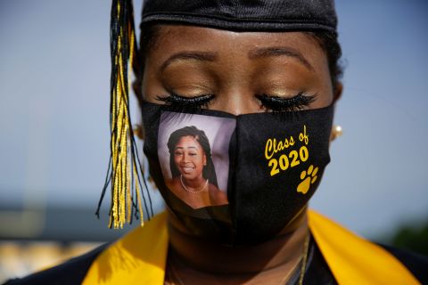 High school senior Yasmine Protho wears a photo of herself on her protective mask as she graduates in Cusseta, Georgia, on May 15. Graduates were recognized in small groups, with limited guests attending.
