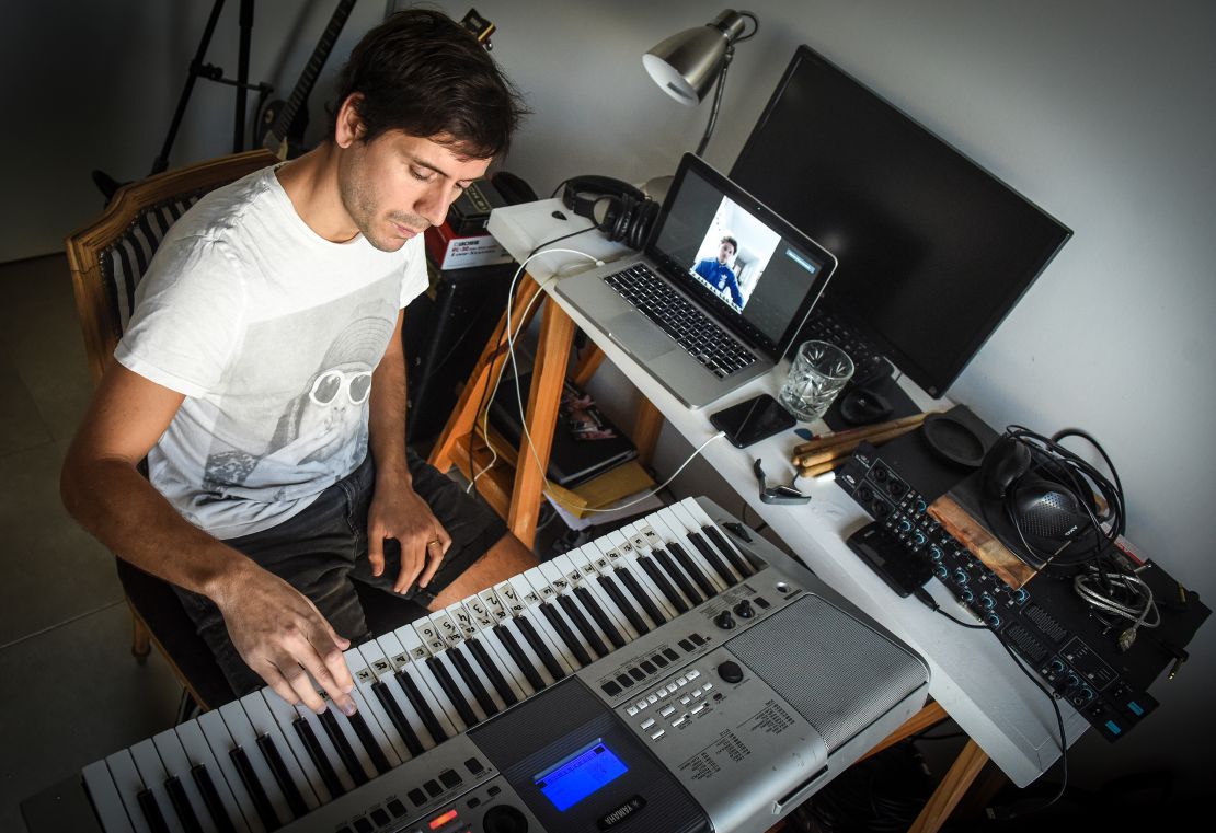 Musician Tati Diaz Bonilla plays the keyboard as a student listens and watches through Zoom during an online lesson from his apartment in Buenos Aires, Argentina. (Marcelo Endelli/Getty Images)