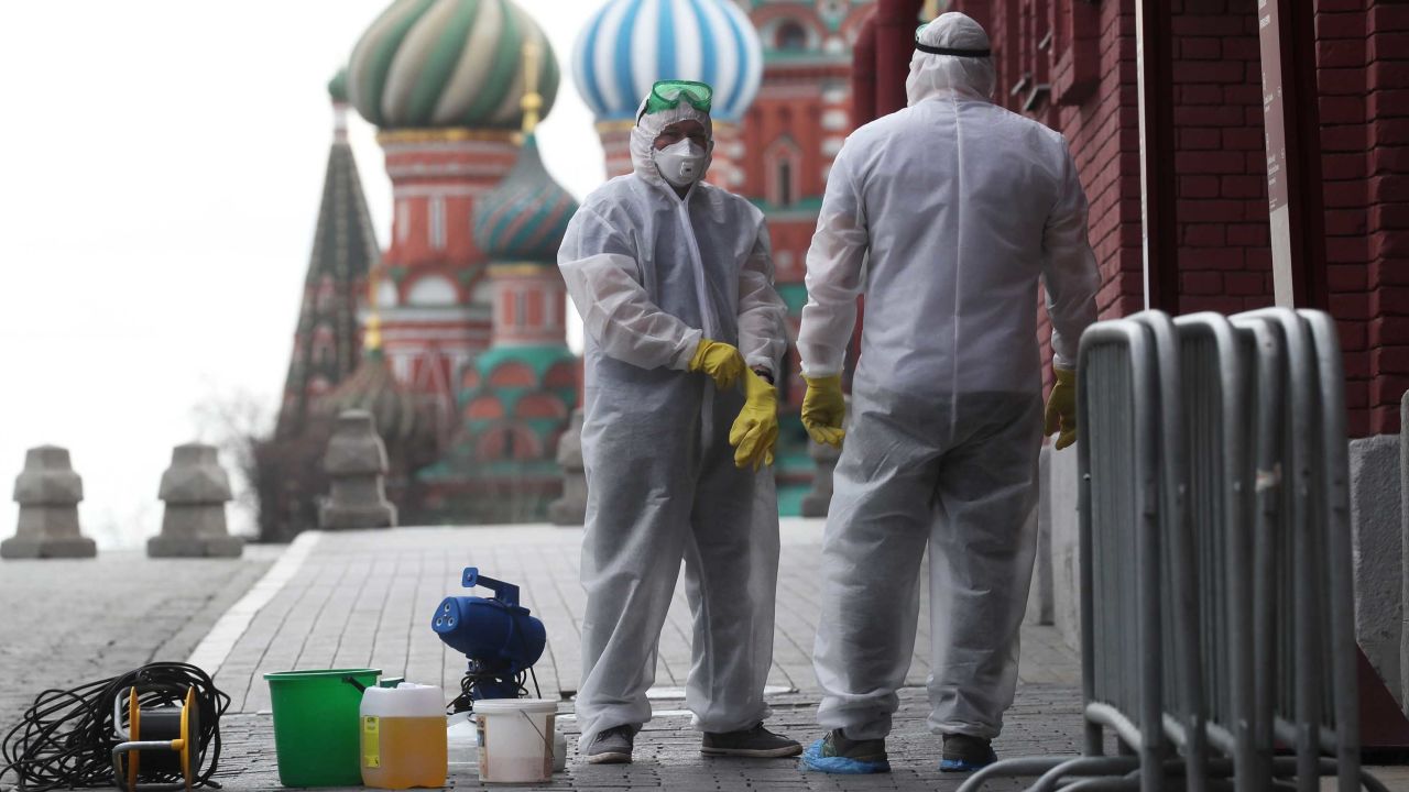 People in protective gear disinfecting Red Square in Moscow.