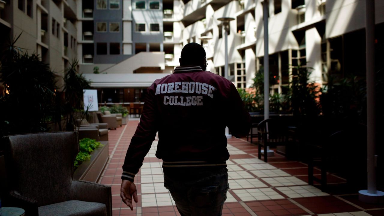 Morehouse College senior Lanarion "LTL" Norwood Jr., of Atlanta, walks through a hotel lobby after students were asked to leave the campus amid the pandemic.