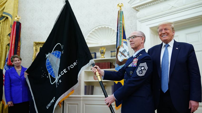 US Space Force Senior Enlisted Advisor CMSgt Roger Towberman, with US President Donald Trump, presents the US Space Force Flag on May 15, 2020, in the Oval Office of the White House in Washington, DC. (Photo by MANDEL NGAN / AFP) (Photo by MANDEL NGAN/AFP via Getty Images)