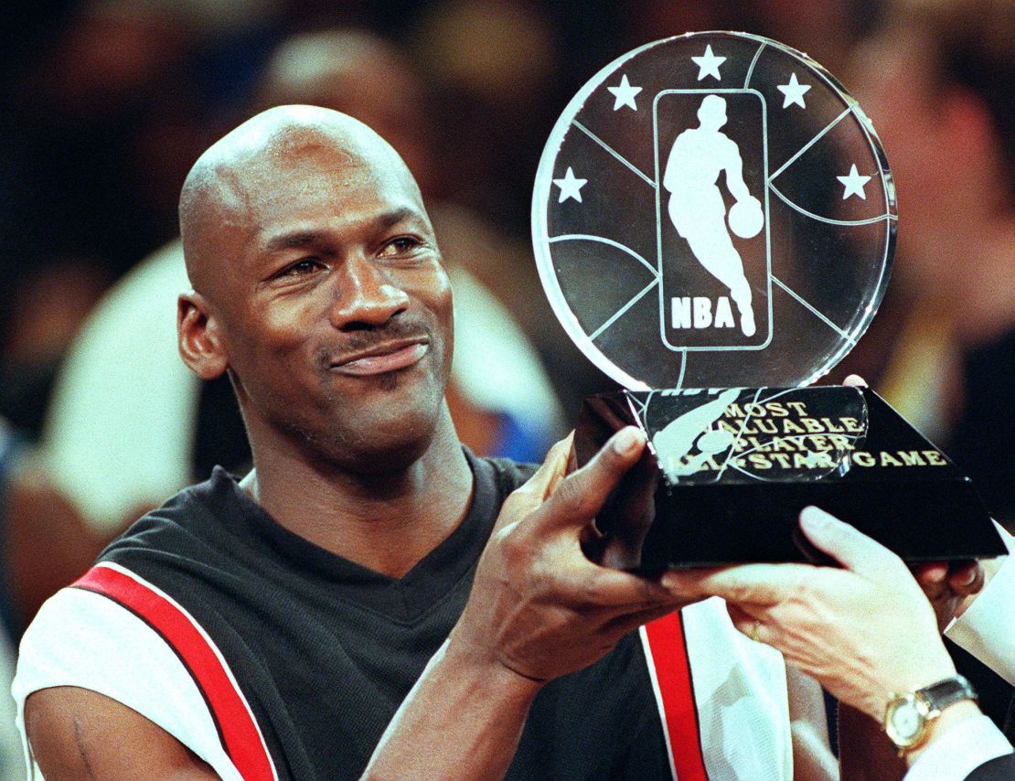 Chicago Bulls' Michael Jordan holds up the Most Valuable Player trophy.