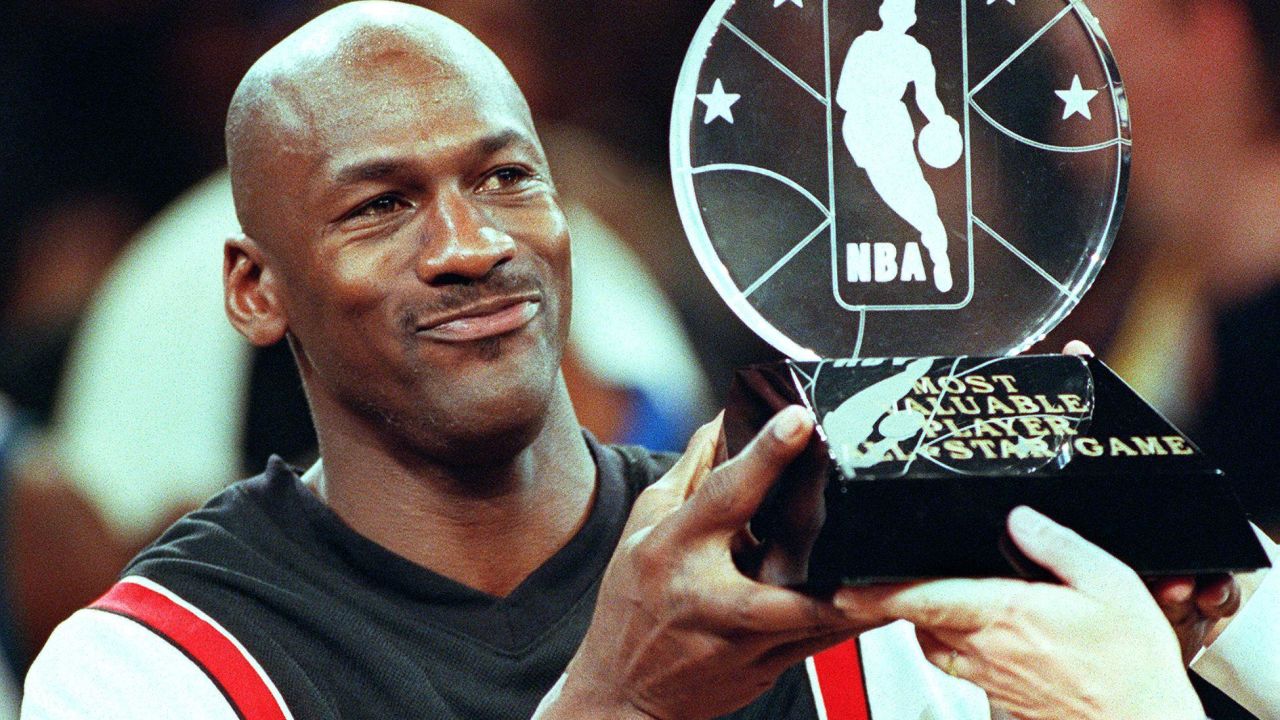 Chicago Bulls' Michael Jordan holds up the Most Valuable Player trophy.