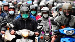 Motorcyclists wearing face masks to prevent the COVID-19 coronavirus, ride during the peak hours while heading to work in Taipei on March 18, 2020. (Photo by Sam Yeh / AFP) (Photo by SAM YEH/AFP via Getty Images)