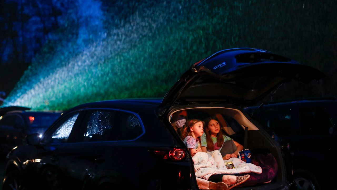 Guests watch a showing of "Trolls World Tour" at the Four Brothers Drive In Theatre, Friday, May 15, 2020, in Amenia, N.Y., during the coronavirus pandemic. (AP Photo/John Minchillo)