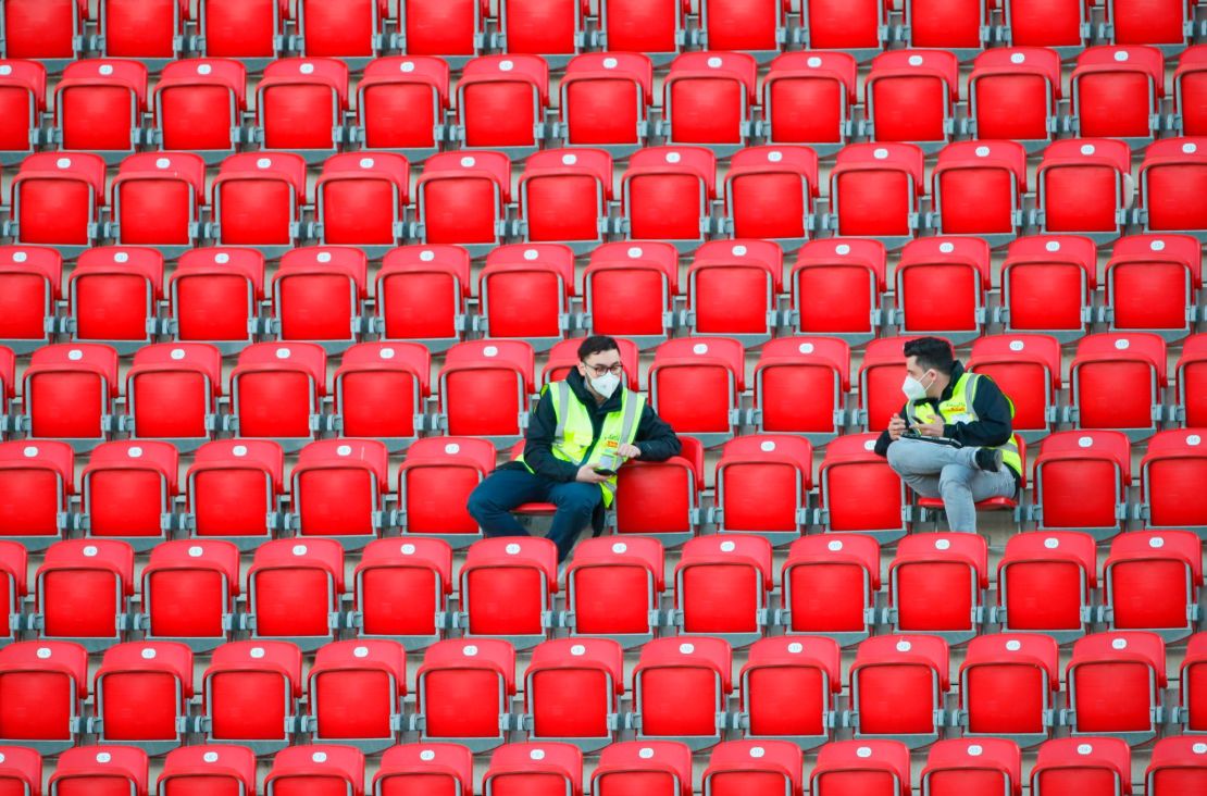 Stewards wearing protective face masks sit in the vacant stands at Union Berlin's home stadium, with all Bundesliga matches until the end of the season being played behind closed doors.
