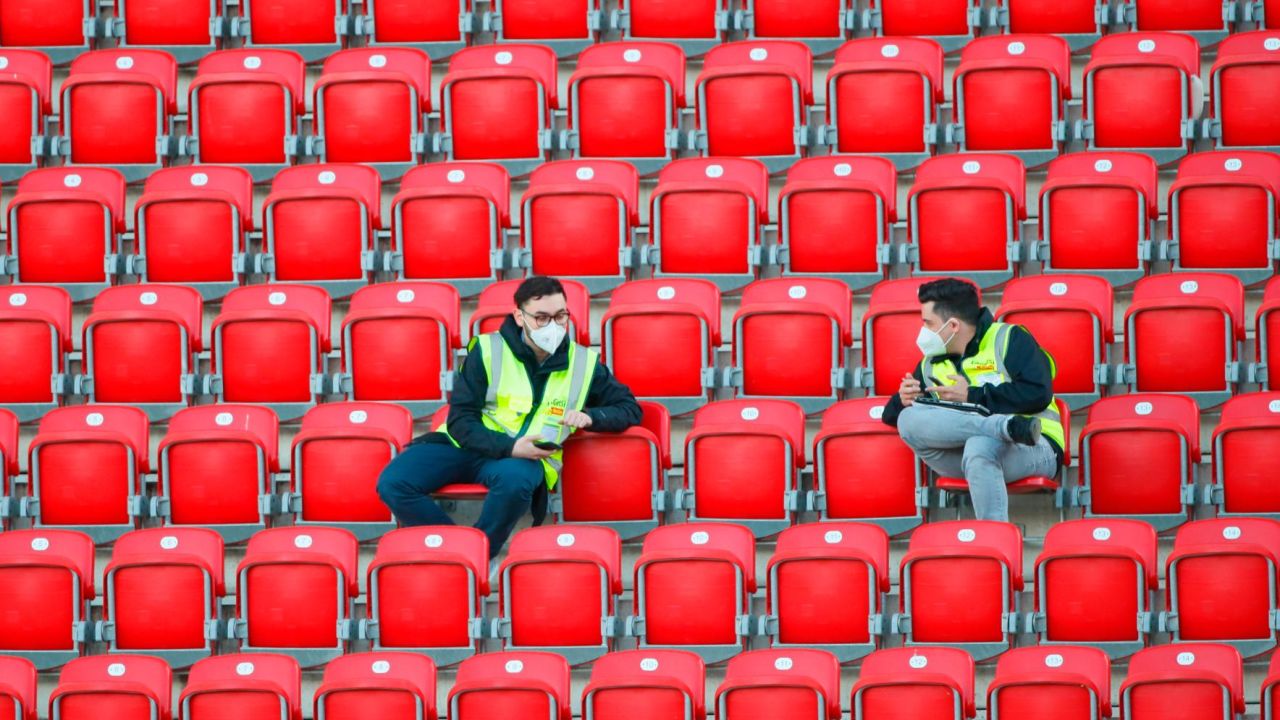 Stewards wearing protective face masks sit in the vacant stands at Union Berlin's home stadium, with all Bundesliga matches until the end of the season being played behind closed doors.
