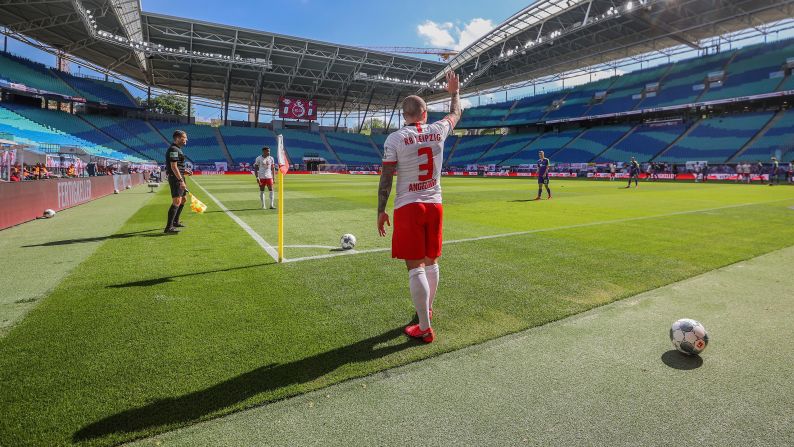 Angelino, a professional soccer player with the German club RB Leipzig, takes a corner kick during a Bundesliga match against Freiburg on May 16, 2020. The stadium was nearly empty, as <a href="index.php?page=&url=https%3A%2F%2Fwww.cnn.com%2F2020%2F05%2F15%2Ffootball%2Fbundesliga-return-soccer-safety-spt-intl%2Findex.html" target="_blank">no more than 322 people</a> were able to attend each Bundesliga match until the end of the season. 