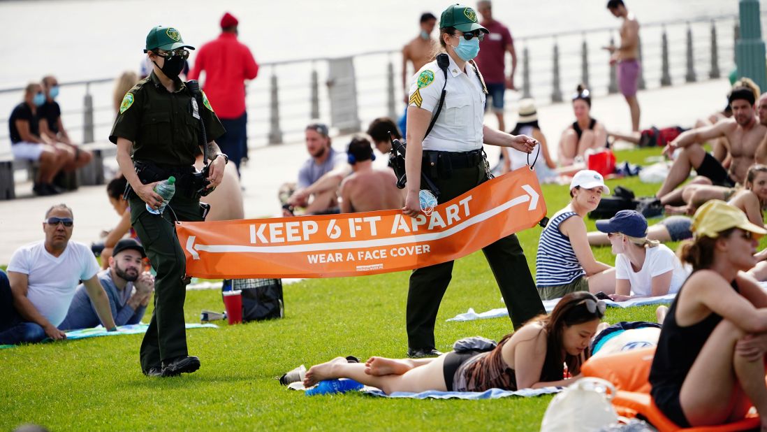 Police walk through New York's Hudson River Park with a reminder about social distancing on May 16.