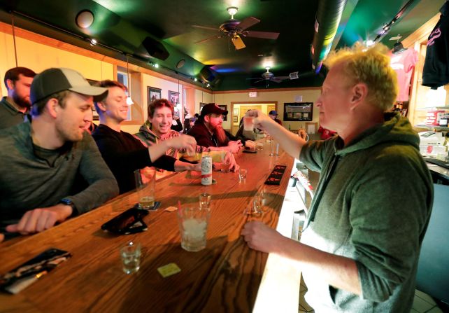 Owner Michael Mattson toasts the re-opening of the Friends and Neighbors bar in Appleton, Wisconsin, following the Wisconsin Supreme Court's decision <a href="index.php?page=&url=https%3A%2F%2Fwww.cnn.com%2F2020%2F05%2F13%2Fpolitics%2Fwisconsin-supreme-court-strikes-down-stay-at-home-order%2Findex.html" target="_blank">to strike down the state's stay-at-home order</a> on May 13.