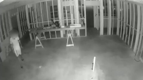 Night video shows a man walking around the home under construction.