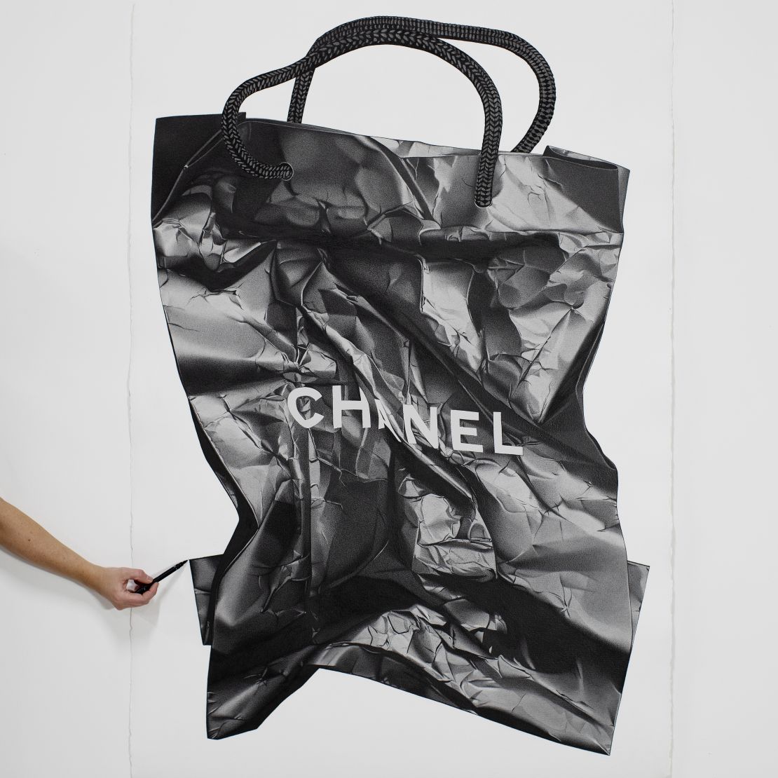A photorealistic illustration of a Chanel shopping bag by CJ Hendry