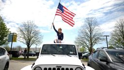 A protestor waves an American flag as she attends an "Open New York" rally in Commack, on Long Island, New York, on May 14. 
