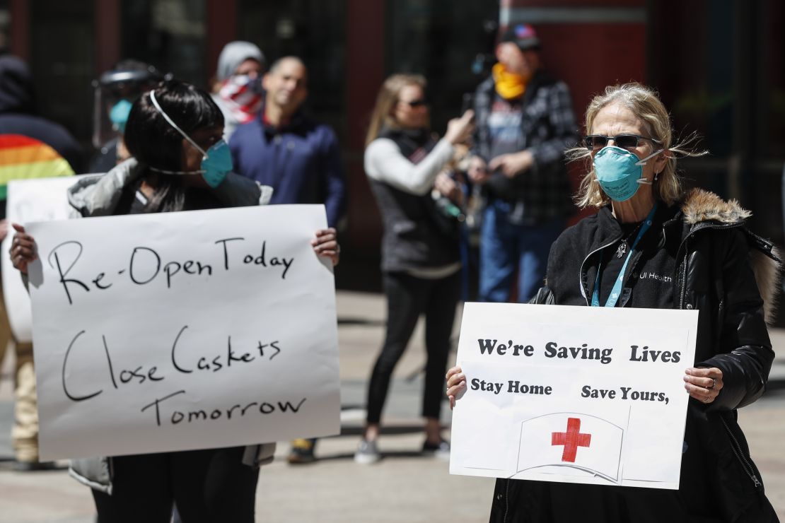 A registered nurse holds a sign during a protest demanding to reopen the Illinois economy on May 1 in Chicago.