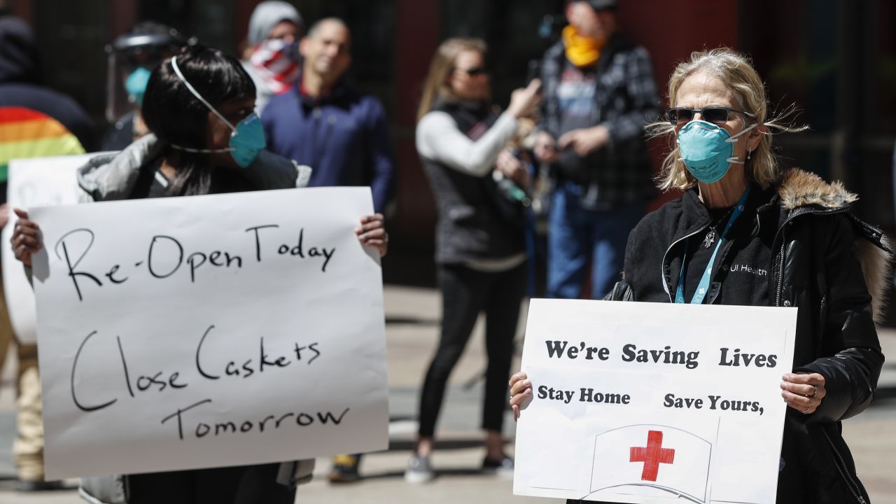 A registered nurse holds a sign during a protest demanding to reopen the Illinois economy on May 1 in Chicago.