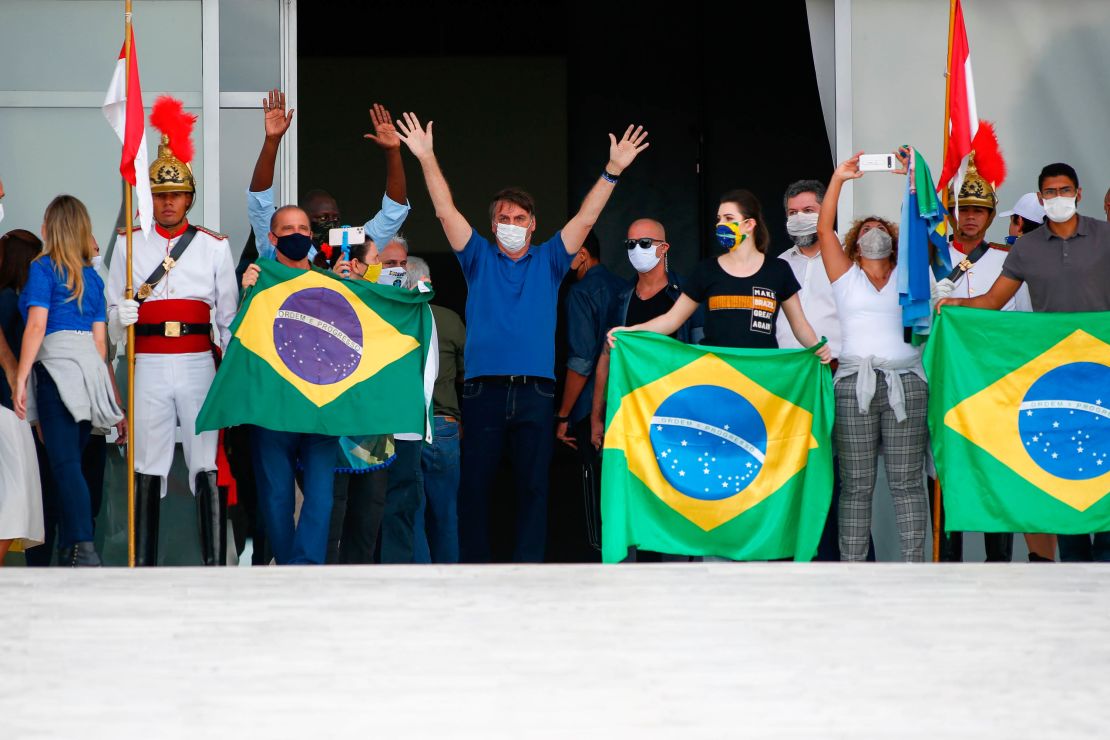 Bolsonaro waves to supporters during a rally in Brasilia on Sunday.