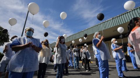 Health professionals hold balloons as they honour colleagues who have died of the coronavirus, outside Sao Paulo University Hospital.