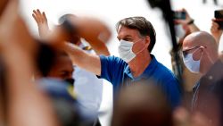 Brazilian President Jair Bolsonaro (C) waves to supporters duering a rally in Brasilia on May 17, 2020, amid the novel coronavirus pandemic. - Brazil's COVID-19 death toll passed 15,000 on Saturday, official data showed, while its number of infections topped 230,000, making it the country with the fourth-highest number of cases in the world. (Photo by Sergio LIMA / AFP) (Photo by SERGIO LIMA/AFP via Getty Images)