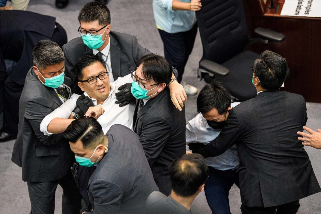 Lam Cheuk-ting is removed by security personnel following the scuffle.