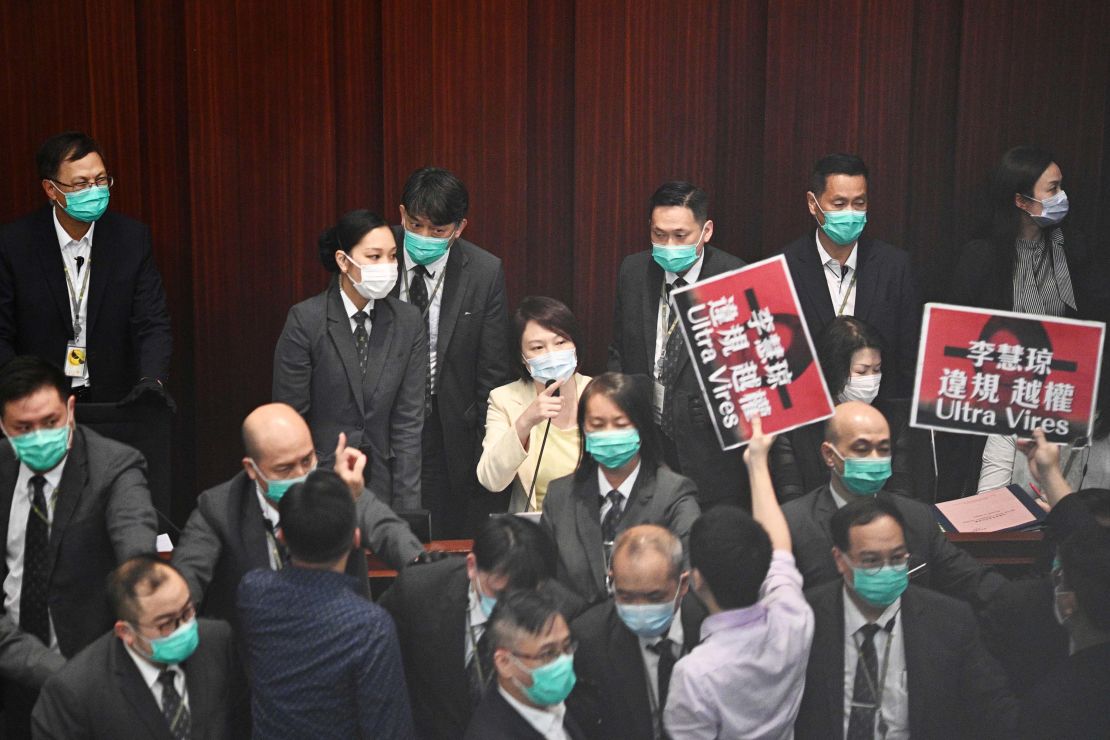 Pro-Beijing lawmaker Starry Lee, center, gestures towards pro-democracy lawmakers.