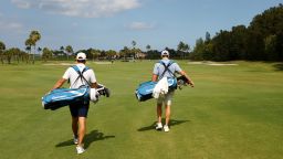 JUNO BEACH, FLORIDA - MAY 17: Dustin Johnson of the American Nurses Foundation team and Rory McIlroy of the American Nurses Foundation team carry their bags during the TaylorMade Driving Relief Supported By UnitedHealth Group on May 17, 2020 at Seminole Golf Club in Juno Beach, Florida. (Photo by Mike Ehrmann/Getty Images)