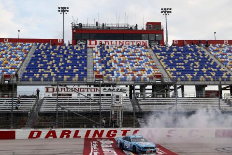 Kevin Harvick celebrates with a burnout after winning a NASCAR Cup Series race in Darlington, South Carolina, on May 17, 2020. It was <a href="https://www.cnn.com/world/live-news/coronavirus-pandemic-05-17-20-intl/h_e8560781fc2629b4a53f4aa0f0623dee" target="_blank">NASCAR's first race</a> since its season was halted because of the pandemic. No fans were in attendance.