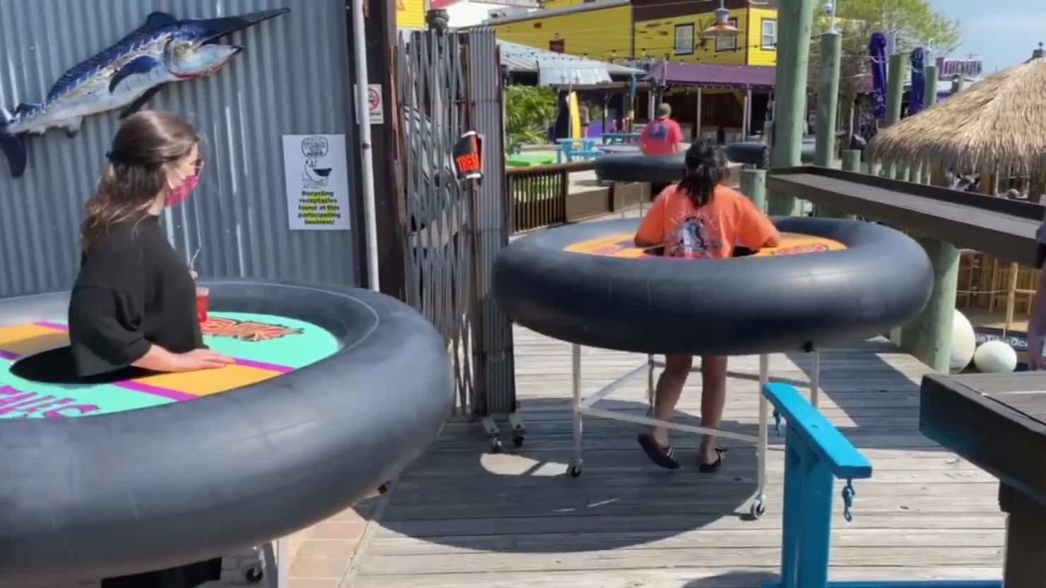 A restaurant and bar in Ocean City, Maryland, has created special bumper tables with inner tubes to keep customers six feet apart while they walk around. The tubes are on a metal frame and the customer stands in the middle. 