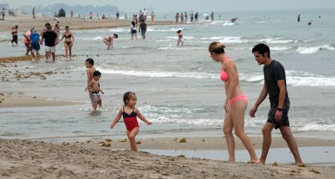 People enjoy the water as Florida's Palm Beach County reopened some beaches on May 18. Social-distancing rules were still in effect.