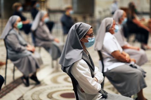 Nuns await a Mass in Rome on May 18. It was the first Mass celebrated by parish priest Marco Gnavi in more than two months.