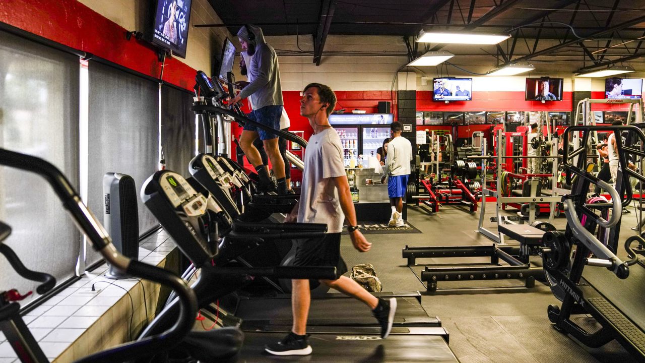 People use the treadmills and other equipment at Optimum Gym in Tampa on Monday, the first day it was back open for members.